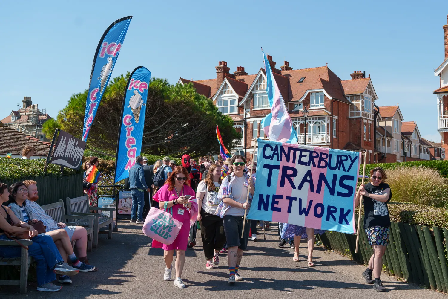Marchers carrying a Canterbury Trans Network banner past onlookers