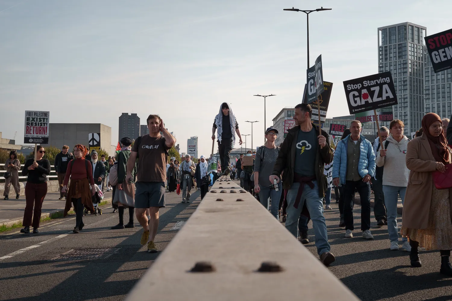 Demonstrators walking across a bridge