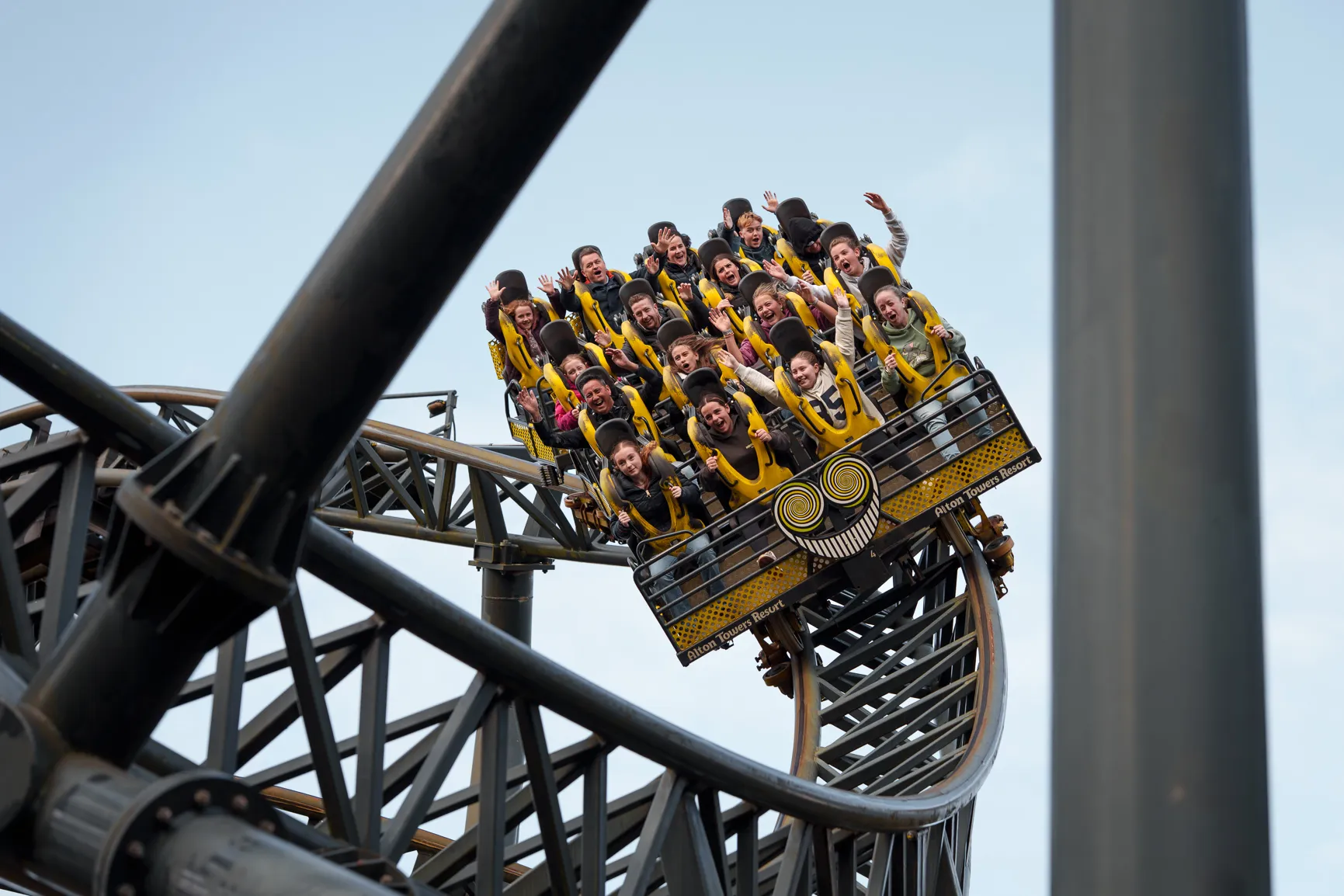 A rollercoaster carrying riders past autumn trees at Alton Towers