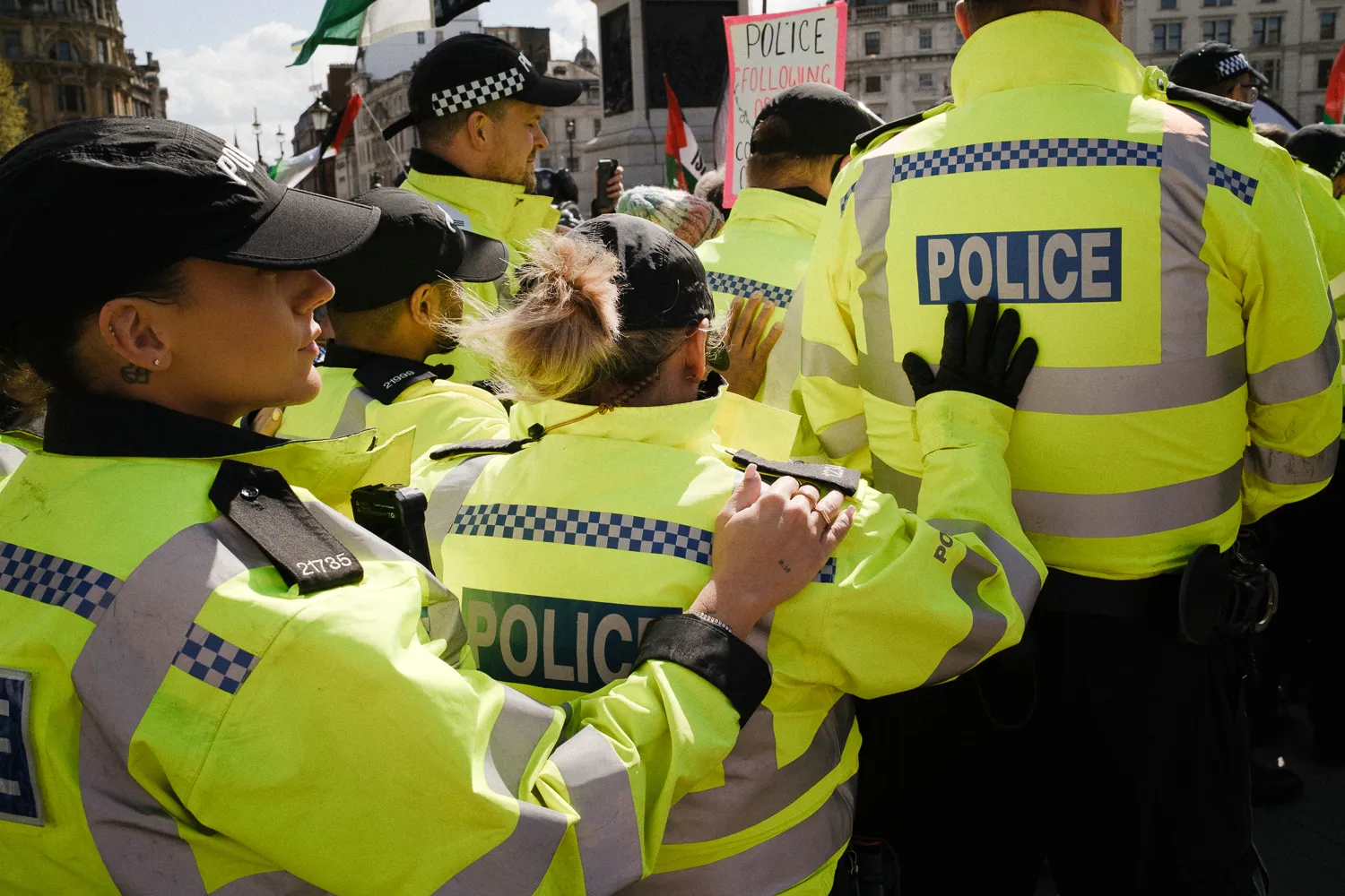A queue of police officers in high-visibility jackets