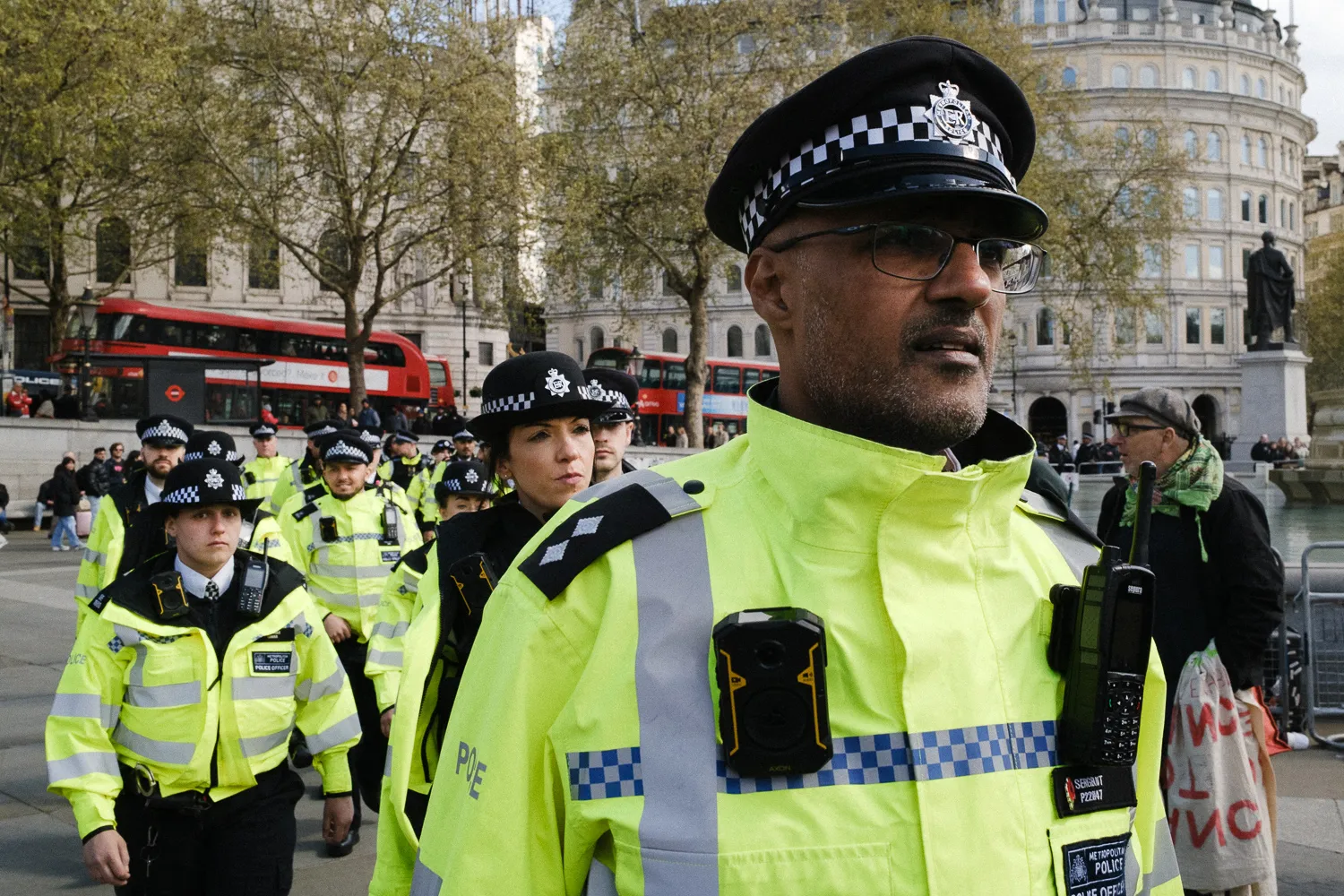 A police inspector in the foreground of a group at Trafalgar Square